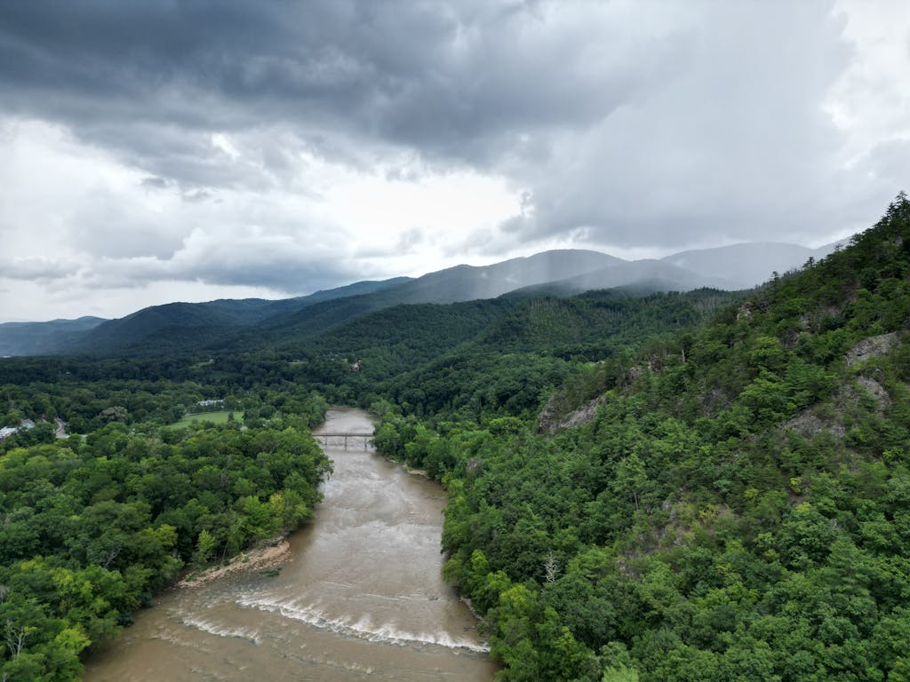Aerial view of lush, green landscape and French Broad River in Hot Springs, NC.